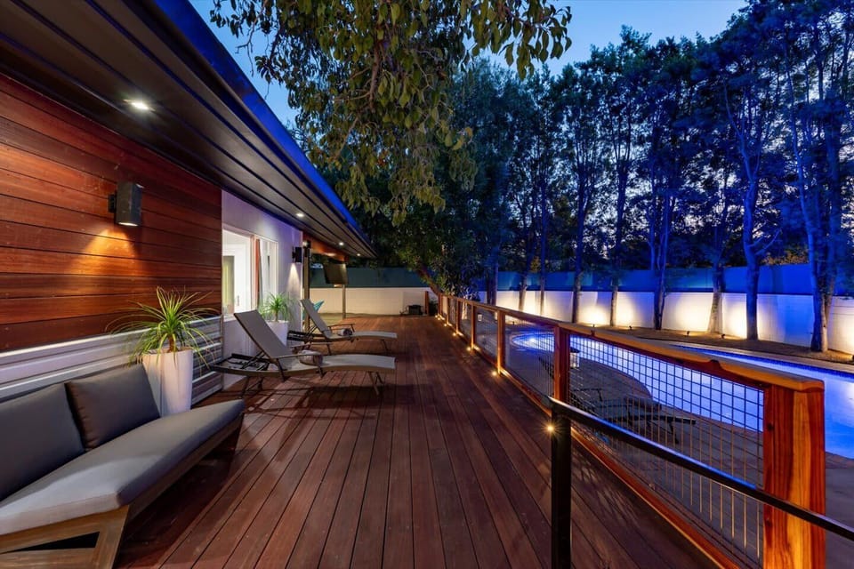Sit on the large deck and enjoy the privacy of the backyard and its wonderful evening lighting