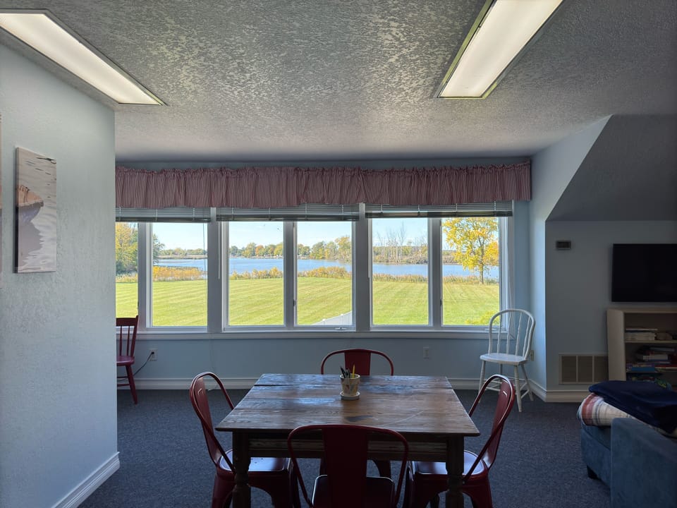 South wing 2nd floor living room has twin bed, tv, couch, and table and chairs