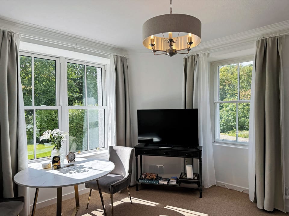Living room with panoramic views of the garden and the sea in the distance
