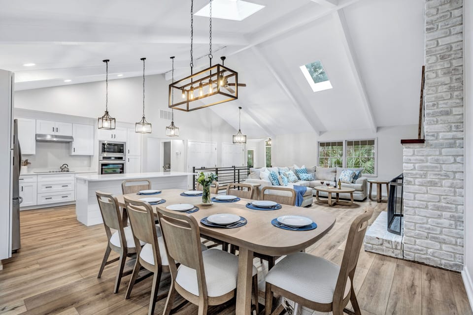 Open floor concept connects the living and dining area with the kitchen, seemingly flowing further to the expansive outdoor deck.