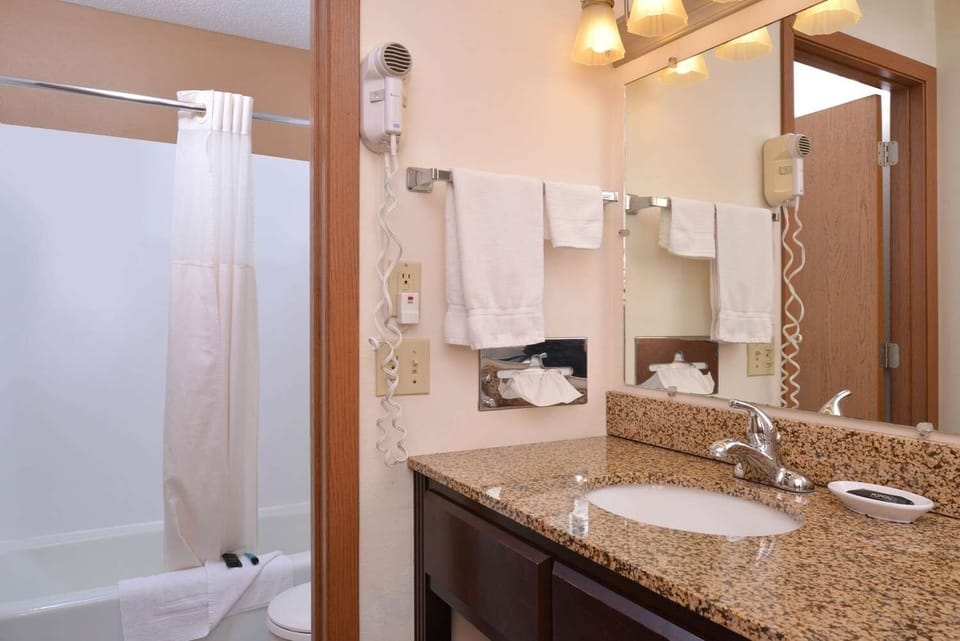 Stretch out on plush beds under warm, calming bedside lights.