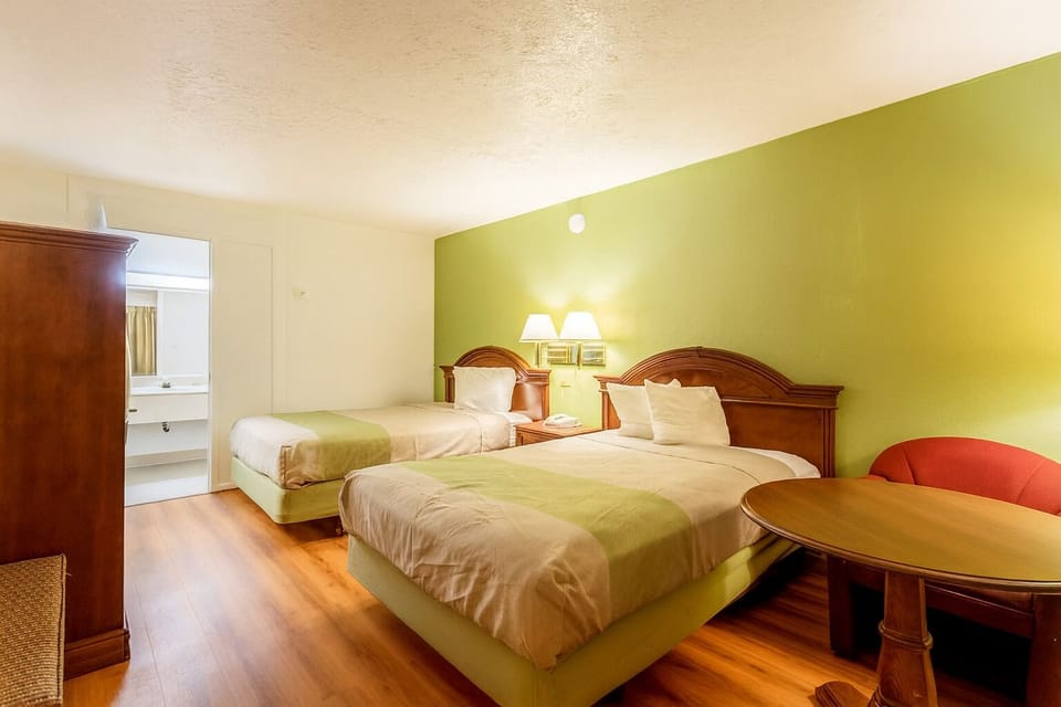 Sleep soundly with two comfortable beds and warm evening light.