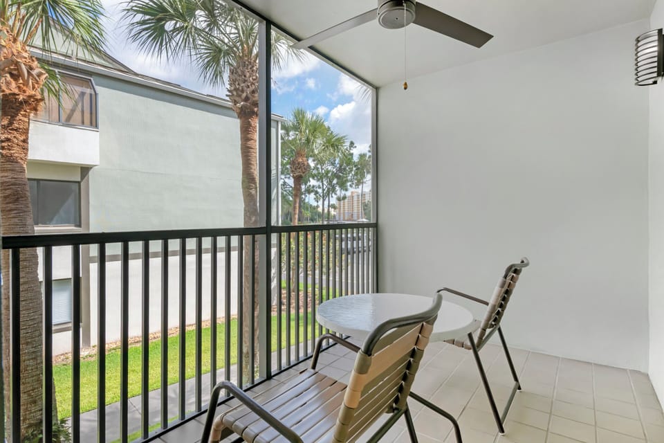 Sip morning coffee on the breezy balcony with palm views.