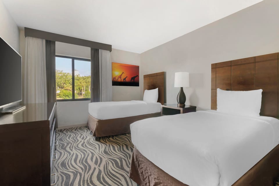 Unit with two double beds. Exact unit will be assigned upon arrival. Views, colors, and decor may vary.