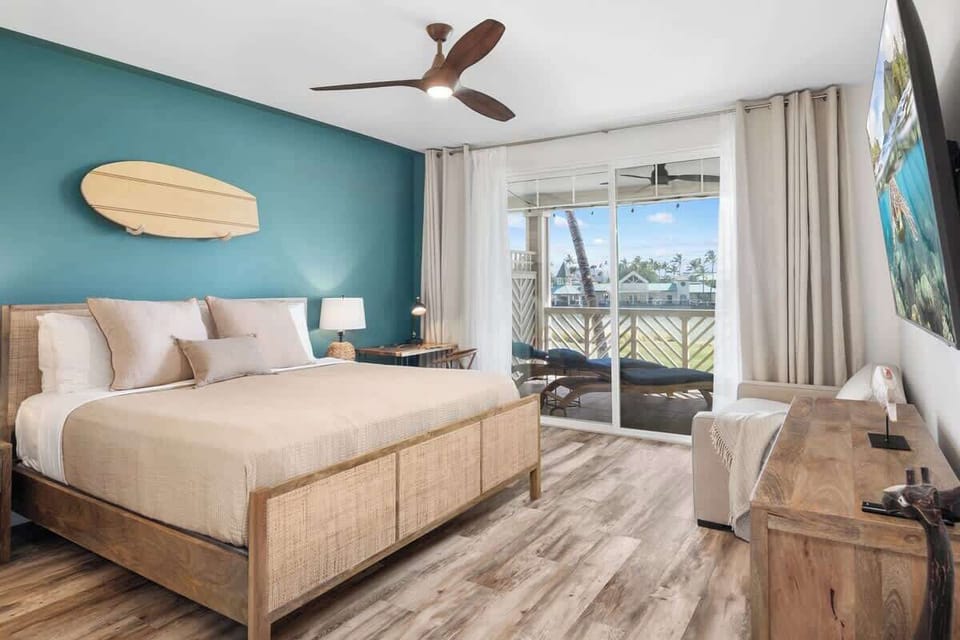 Relax in the spacious master suite featuring a luxurious Stearns & Foster mattress on the king bed, offering breathtaking lake views from the large windows.