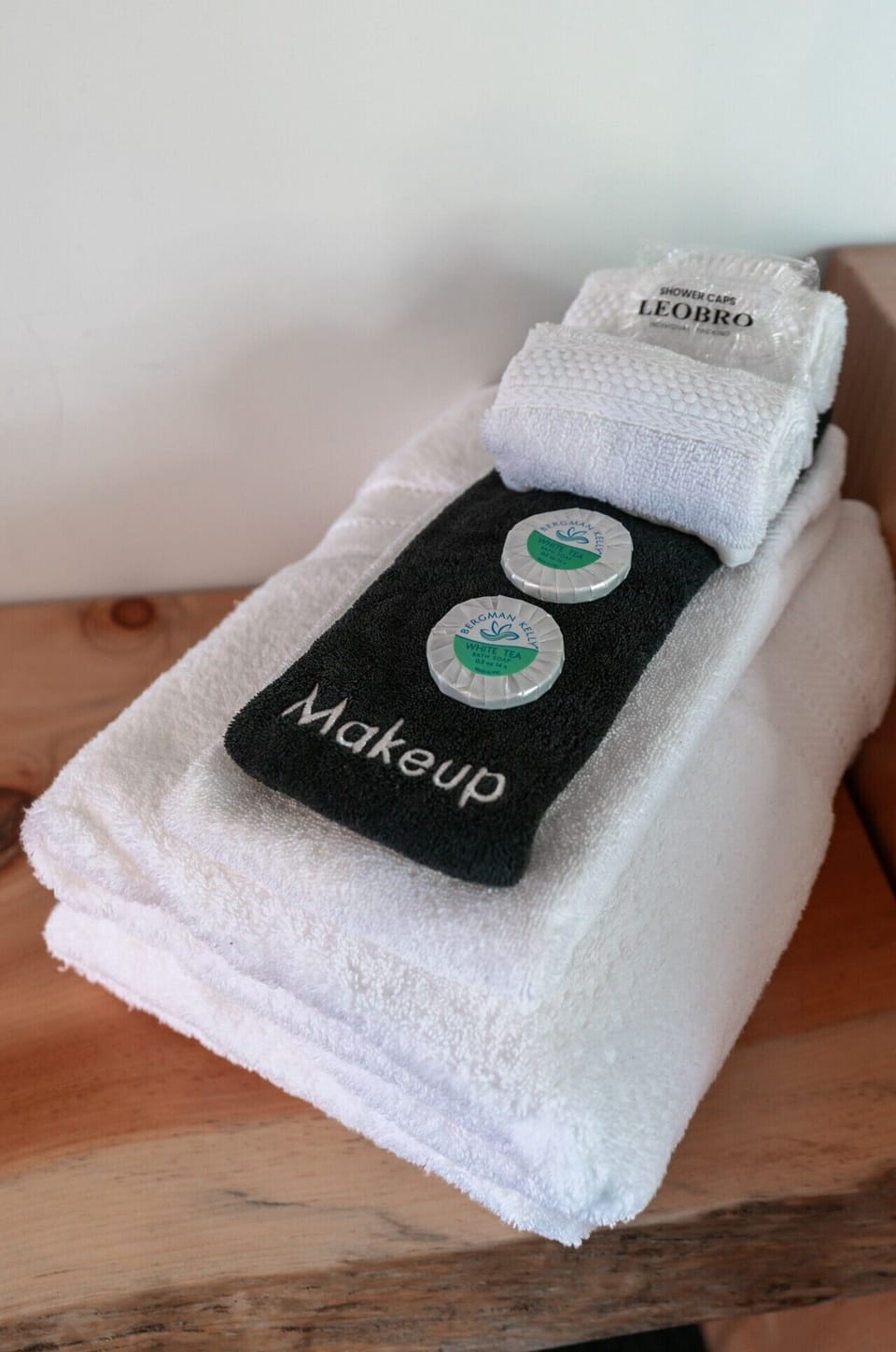 plush towels with soaps and a shower cap