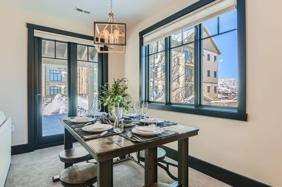 Host elegant dinners at this spacious rustic table, perfectly set for your group. Enjoy the scenic mountain views and natural light as you gather for a memorable meal.