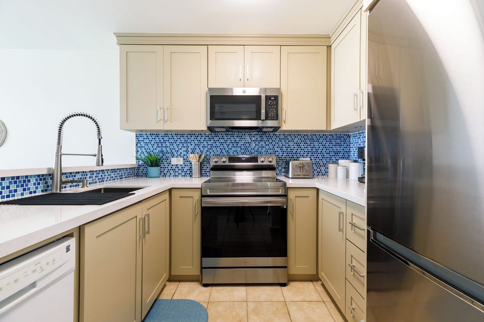 Fully equipped kitchen with coffee maker and breakfast bar with seating for 3.