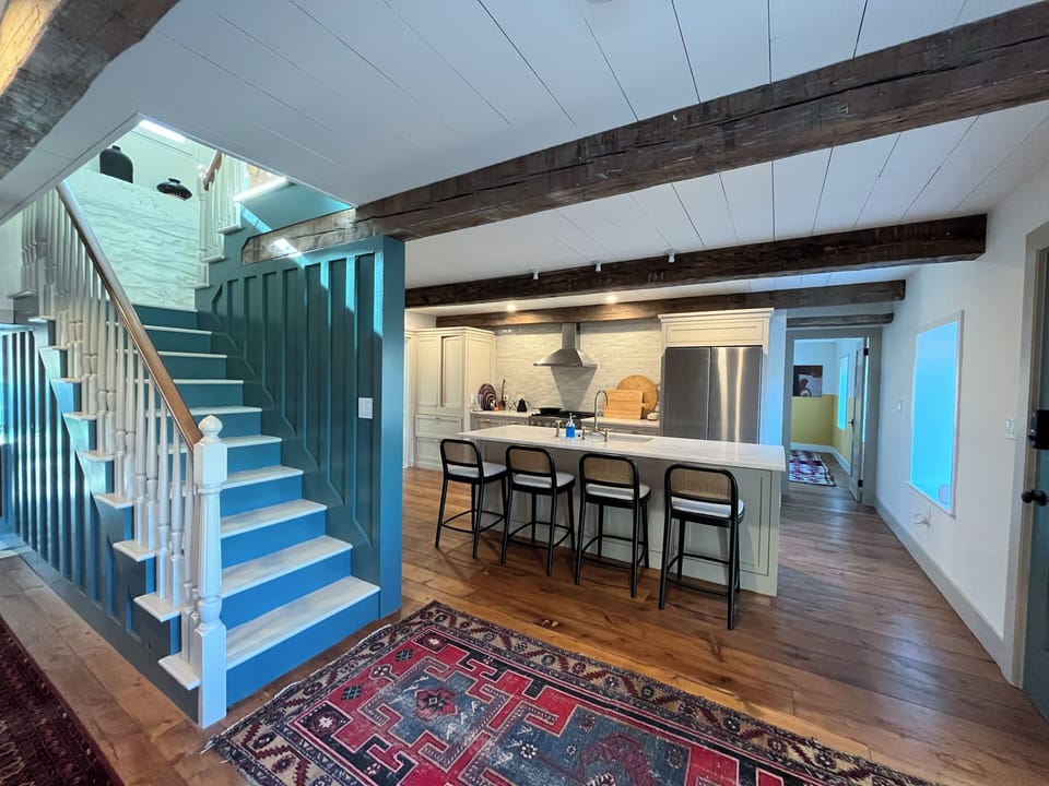 View of the staircase and kitchen from the living room