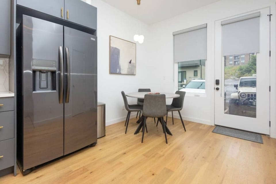 Dining Area: Stylish table for four, modern appliances, and abundant natural light awaits!