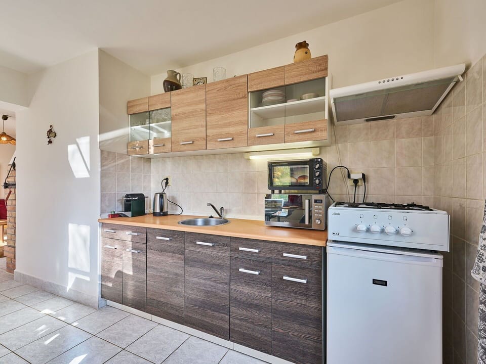 Kitchen, Countertop, Cabinetry, Kitchen Appliance, Furniture, Interior Design, Major Appliance, Flooring, Wood, Drawer