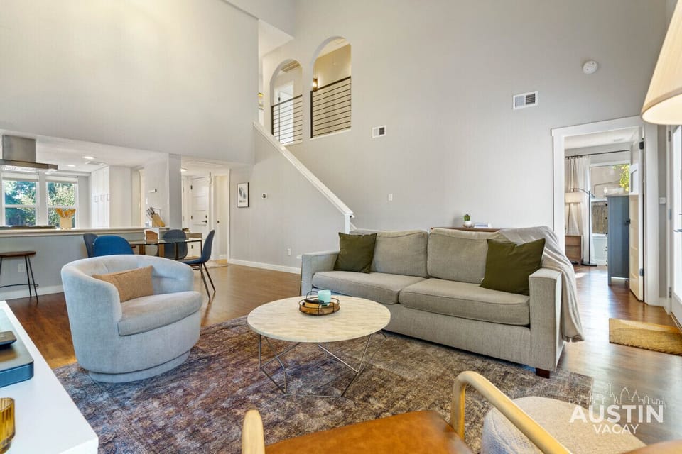 Relax in this modern, open-concept living room with vaulted ceilings and cozy seating