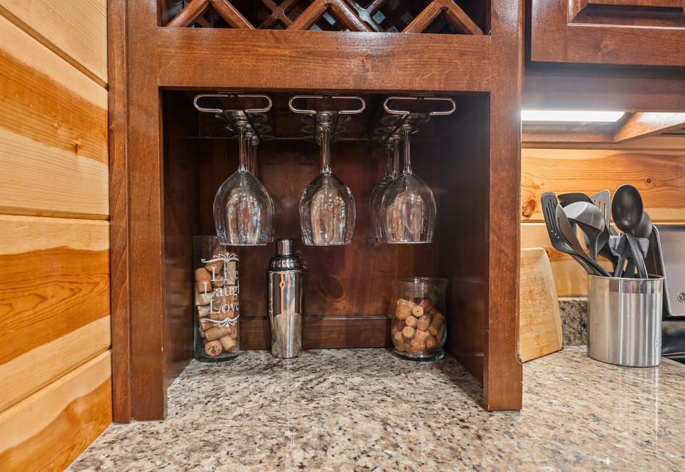 A beautifully organized wine glass rack, perfect for enjoying a glass of wine after a day of adventure.