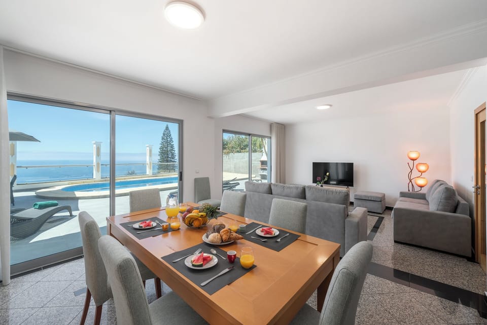 The Open Plan Dining And Sitting Areas Of Atlantic Sunset Villa In Madeira By Ourmadeira Showing The Wonderful Views Of The Sea