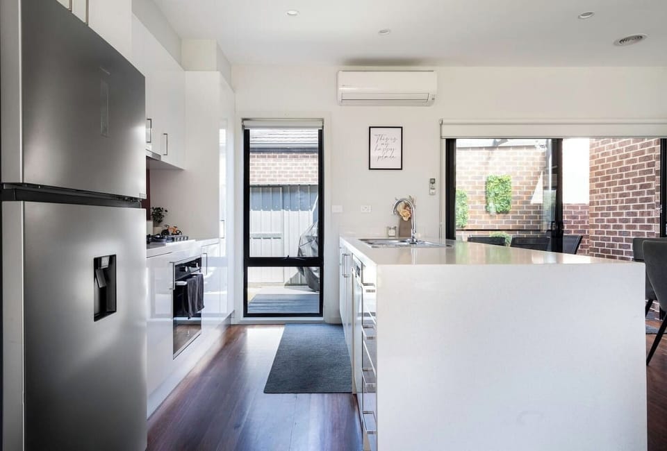  The kitchen comes fully equipped with sleek appliances and cooking utensils to whip up a feast.

