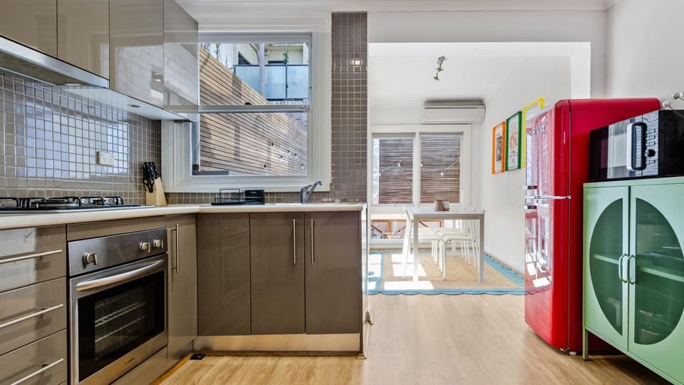 Practical kitchen with a full oven, cooktop, and essential appliances.