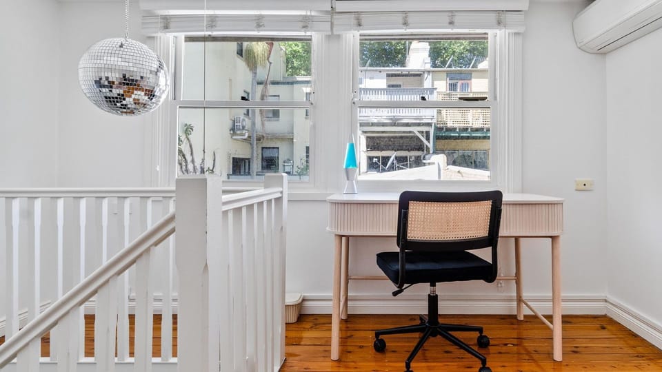 Dedicated desk area on the upper level, ideal for work or study.