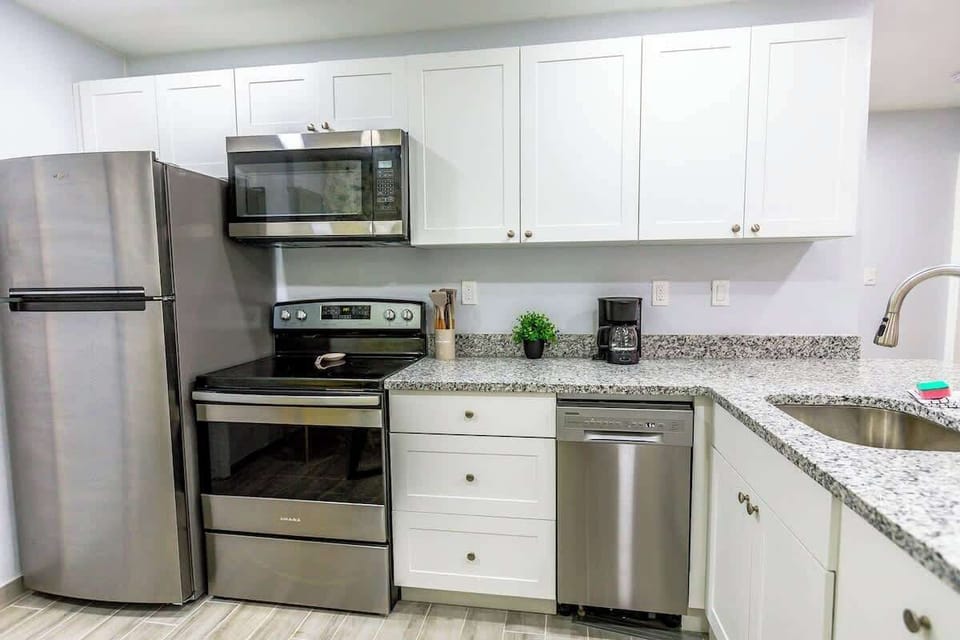 Sleek kitchen with stainless steel appliances. Enjoy cooking here!