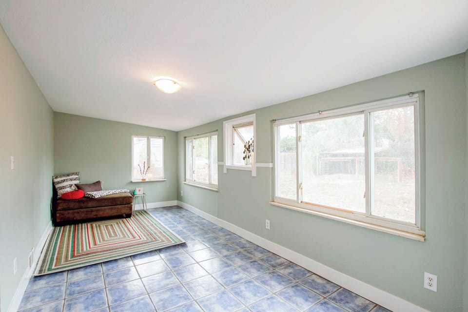 Large sunroom for relaxation. Room now has Flat Screen TV and more artwork. 