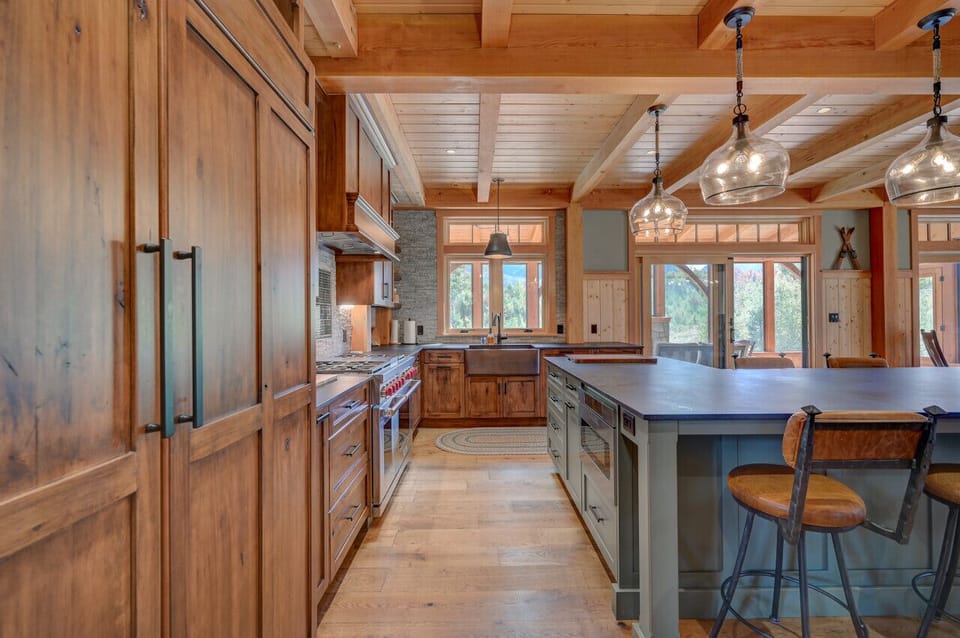 A chef’s gourmet kitchen with an open floor plan and high-end commercial appliances, perfect for cooking and entertaining.