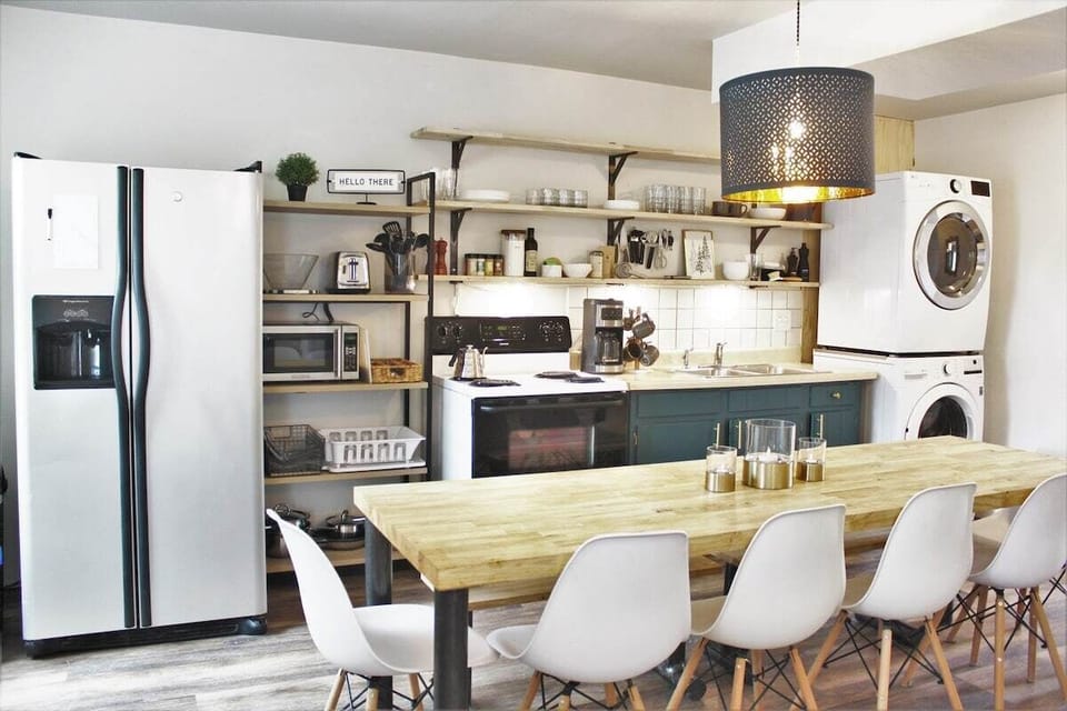 Enjoy meals at the stylish table, surrounded by modern decor and bright, inviting light!
