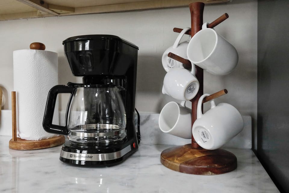 Coffee maker with mugs for your morning brew, adding comfort to your stay.