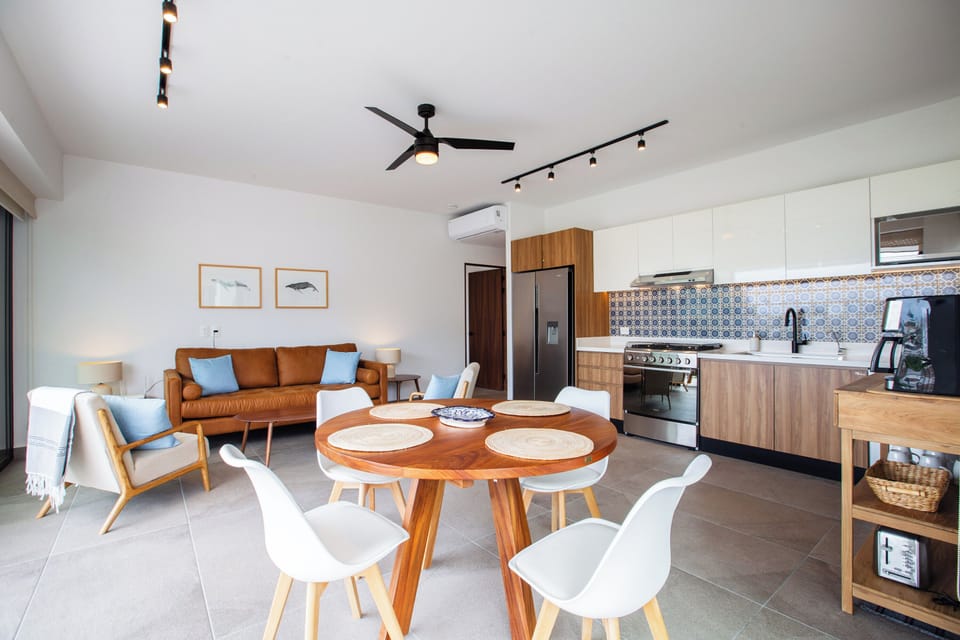 The kitchen is fully equipped and the cozy dining table has a seating for 4