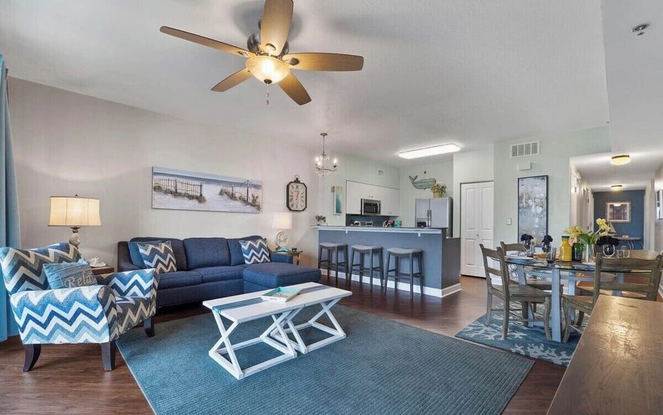 Open concept living area with stylish furnishings, TV, and scenic views. Features a queen size pullout sofa as well.