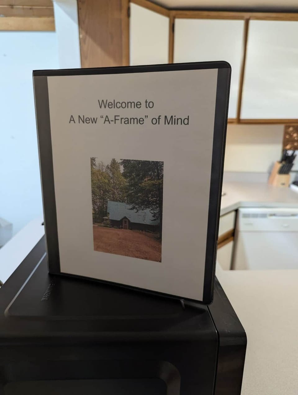 From the entryway, step into the kitchen. A binder, as pictured, provides essential cabin information and helpful local recommendations