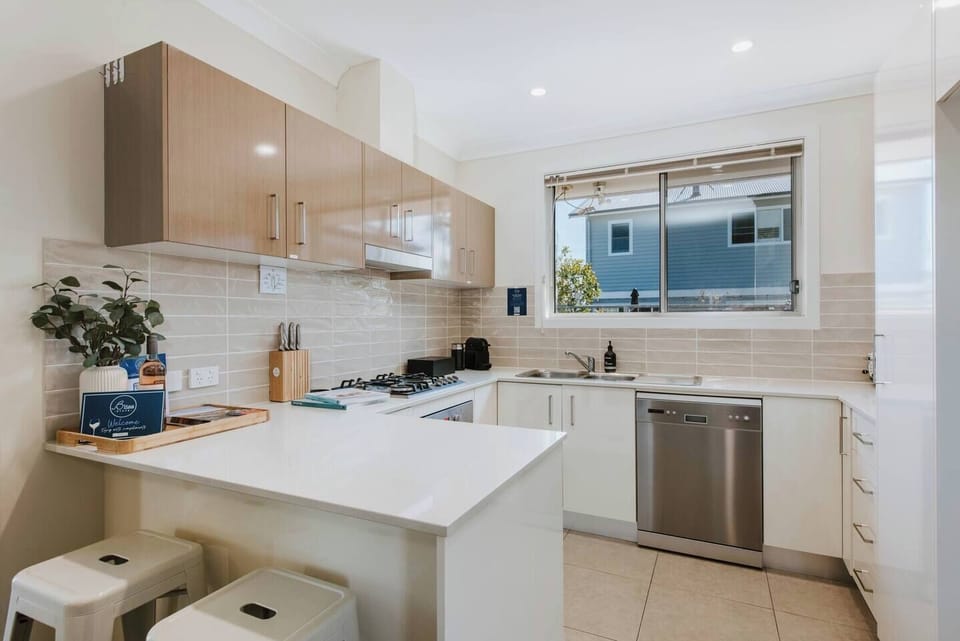 The fully-equipped kitchen offers breakfast bar seating and all the essentials, including a dishwasher for easy clean up.