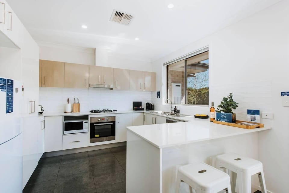 Designed around a breakfast bar, the sleek kitchen makes it easy to prepare meals at home.