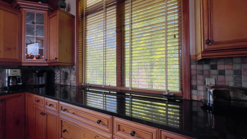 Fully equipped kitchen with stainless appliances and extra seating. 