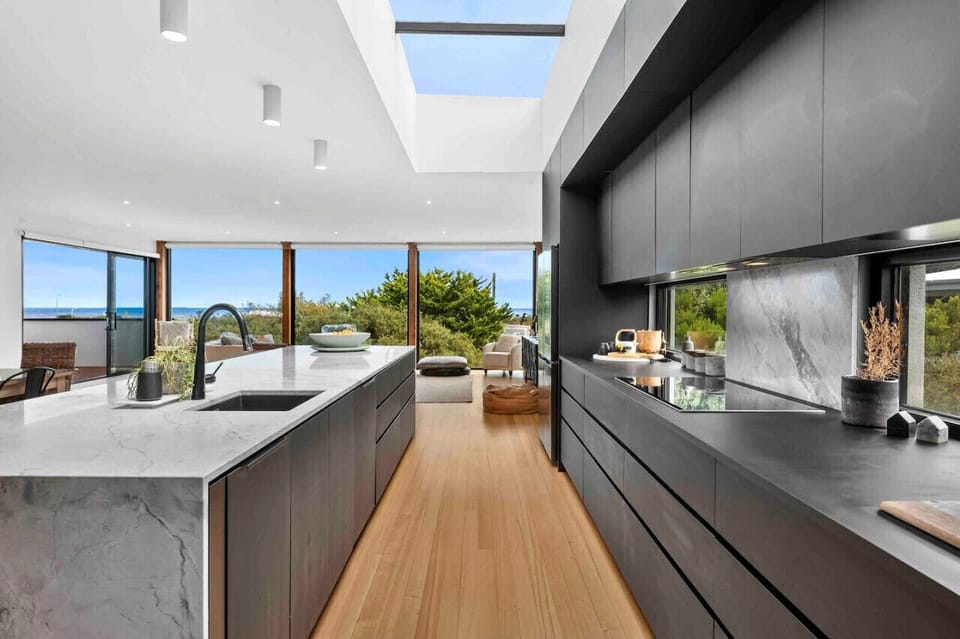 Modern kitchen with large island and views to outdoor living