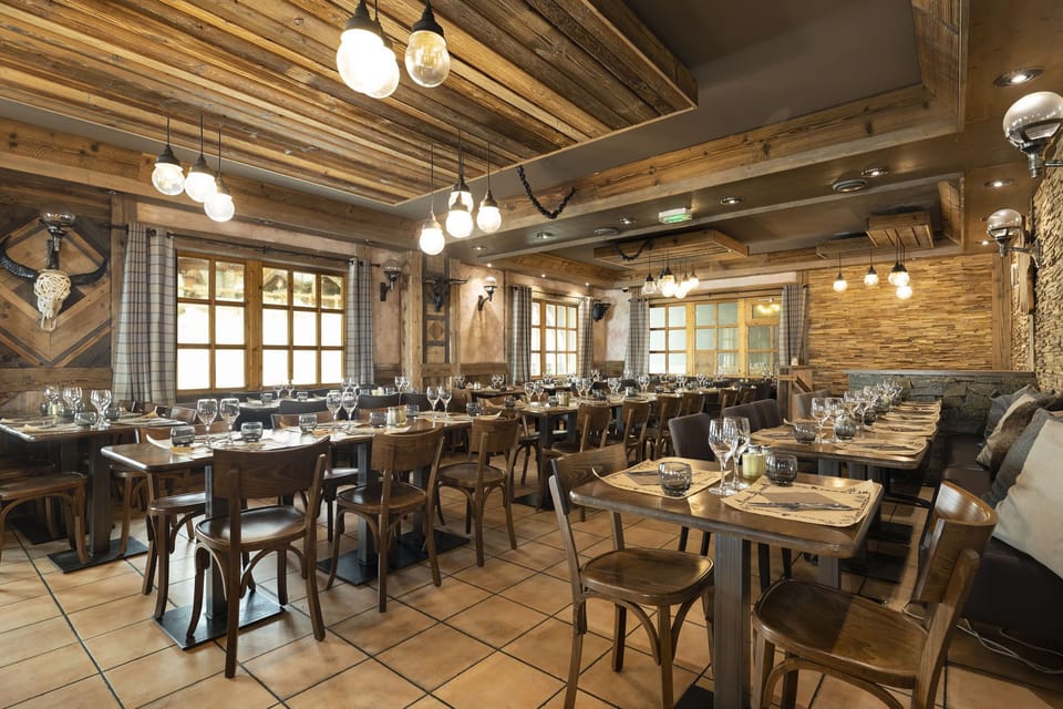 Indulge in the authentic ambiance of Restaurant L’Auberge, where traditional cuisine is served in a warm, rustic setting, perfect for a cozy dining experience.