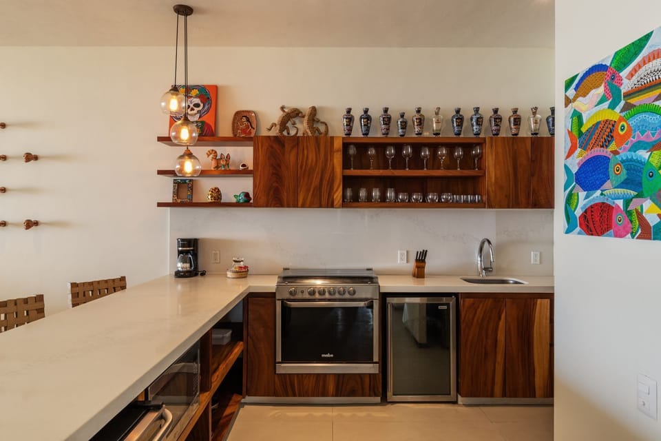 This sleek kitchen features high-end appliances, handcrafted cabinetry, and a beautiful mix of modern and rustic design elements.
