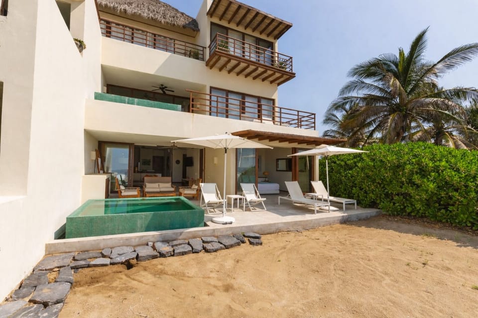 Enjoy direct beach access from this stunning villa, featuring a private plunge pool and spacious outdoor lounging areas.