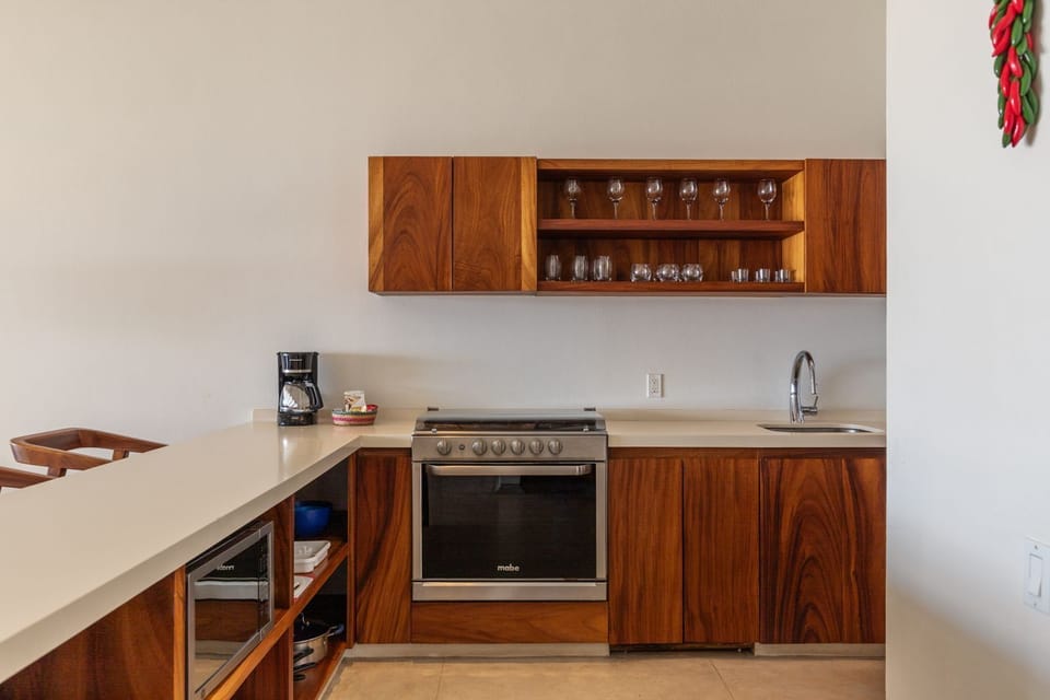 A contemporary kitchen with elegant wood finishes, modern appliances, and a clean, functional design.