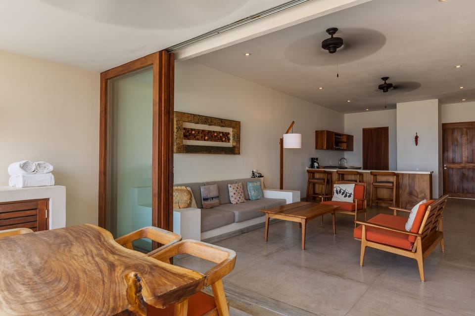 A beautifully designed indoor-outdoor space with wooden accents, natural light, and direct access to the terrace.