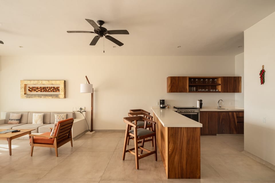 This fully equipped kitchen features rich wood cabinetry, a spacious island, and top-tier appliances for a luxurious cooking experience.
