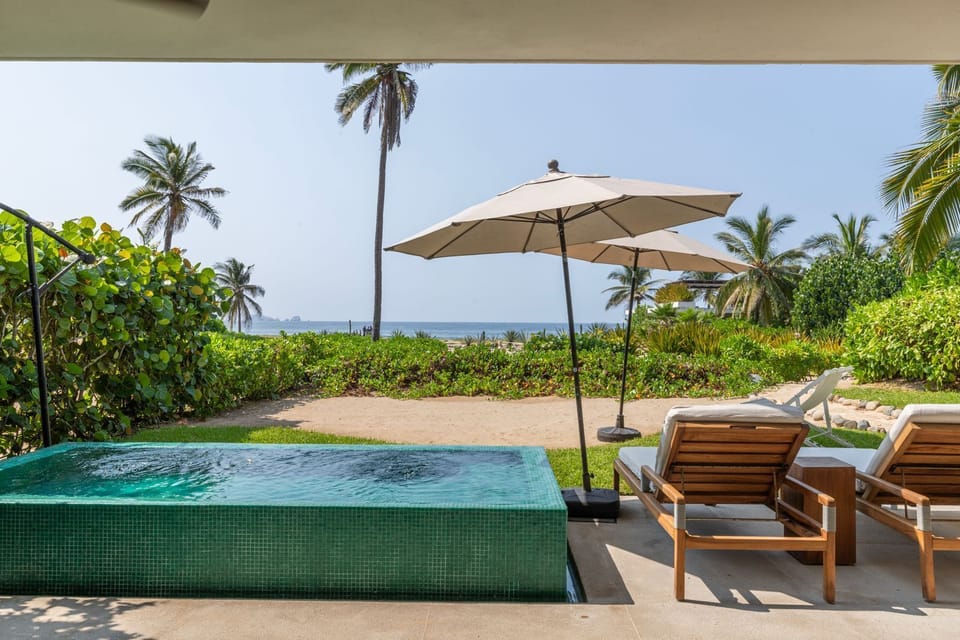 Relax on a stylish patio with breathtaking ocean views, shaded seating, and a refreshing private pool.