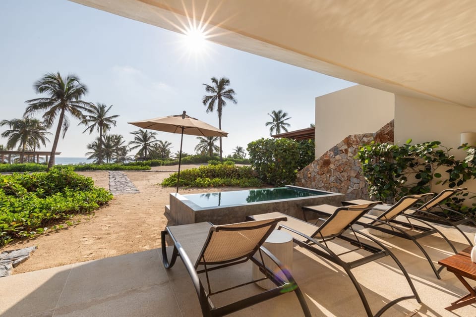 Relax on the sandy shores with plush sun loungers, a shaded pergola, and a refreshing private plunge pool.
