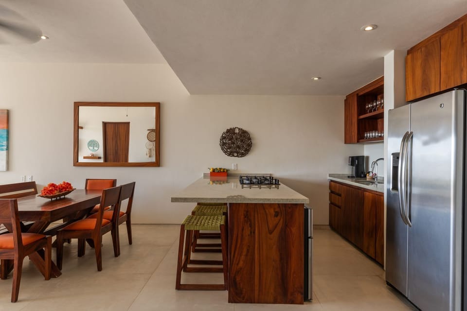 A spacious and modern kitchen with an island, bar seating, and a bright dining space, perfect for entertaining.