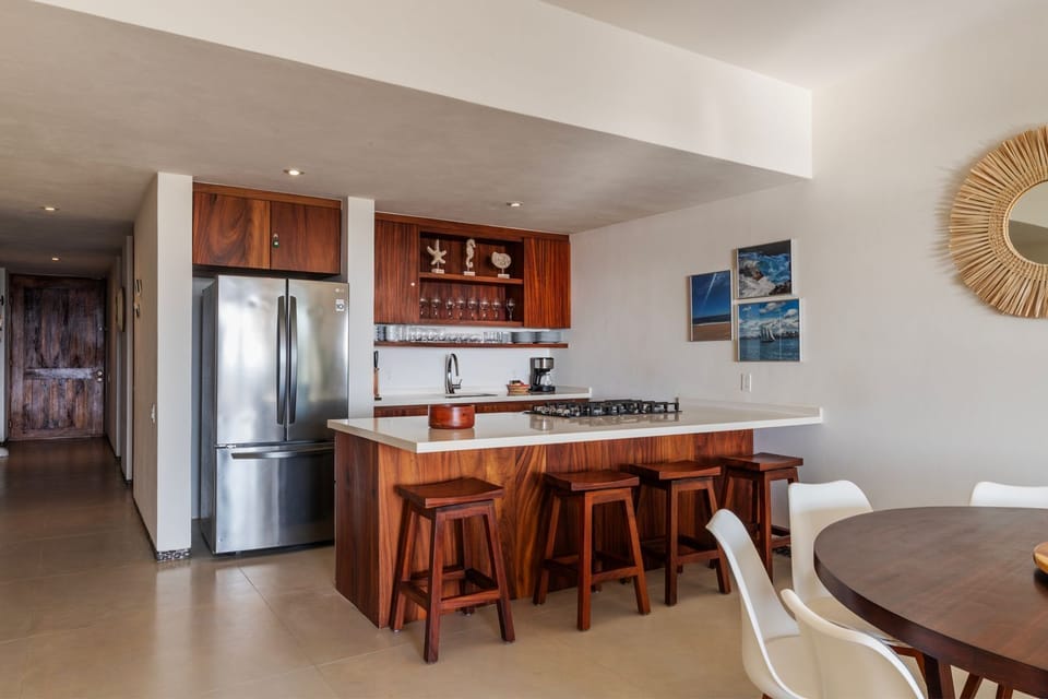 A chef's dream kitchen with high-end appliances, wooden cabinetry, and a large island for casual dining.