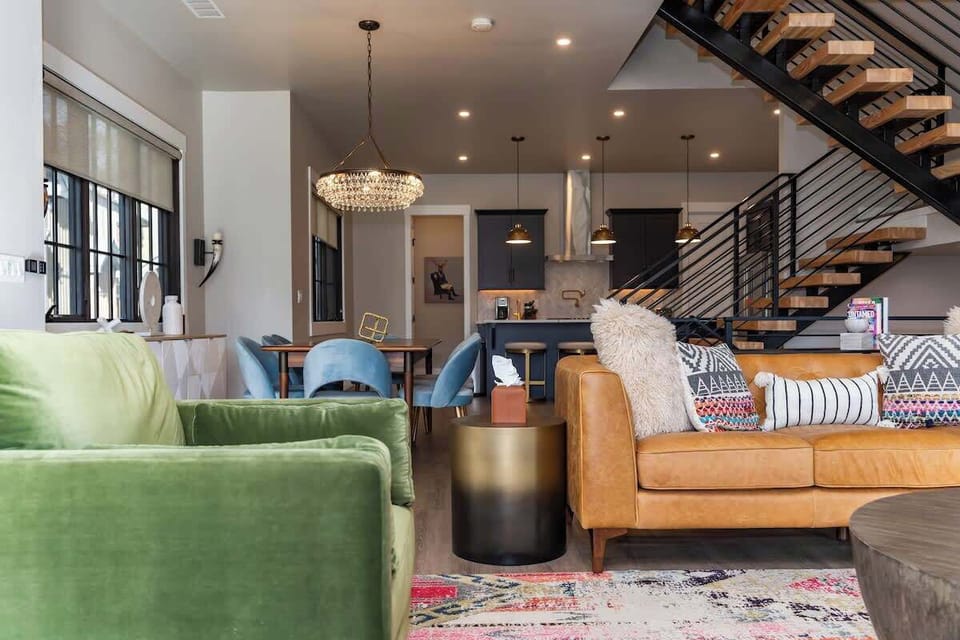 - Bright open living space with seating area dining table and kitchen
- Mix of textures and colors creates a vibrant yet cozy atmosphere
- Perfect setting for gatherings after a day of outdoor adventures