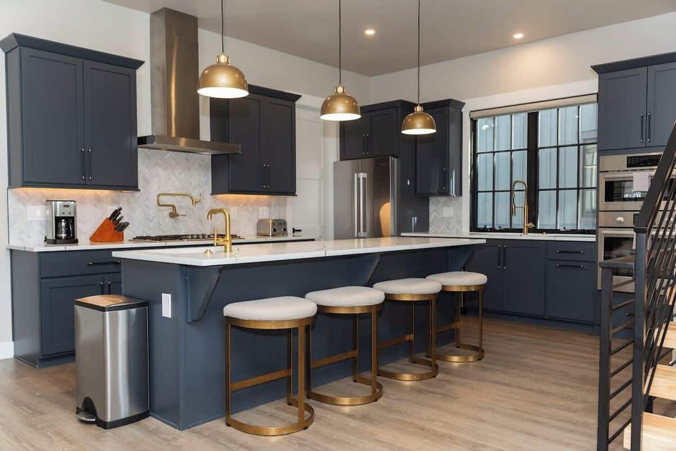- Contemporary kitchen with large island and seating for four
- Stainless steel appliances and plenty of cabinetry for storage
- Open layout ideal for cooking while socializing with guests