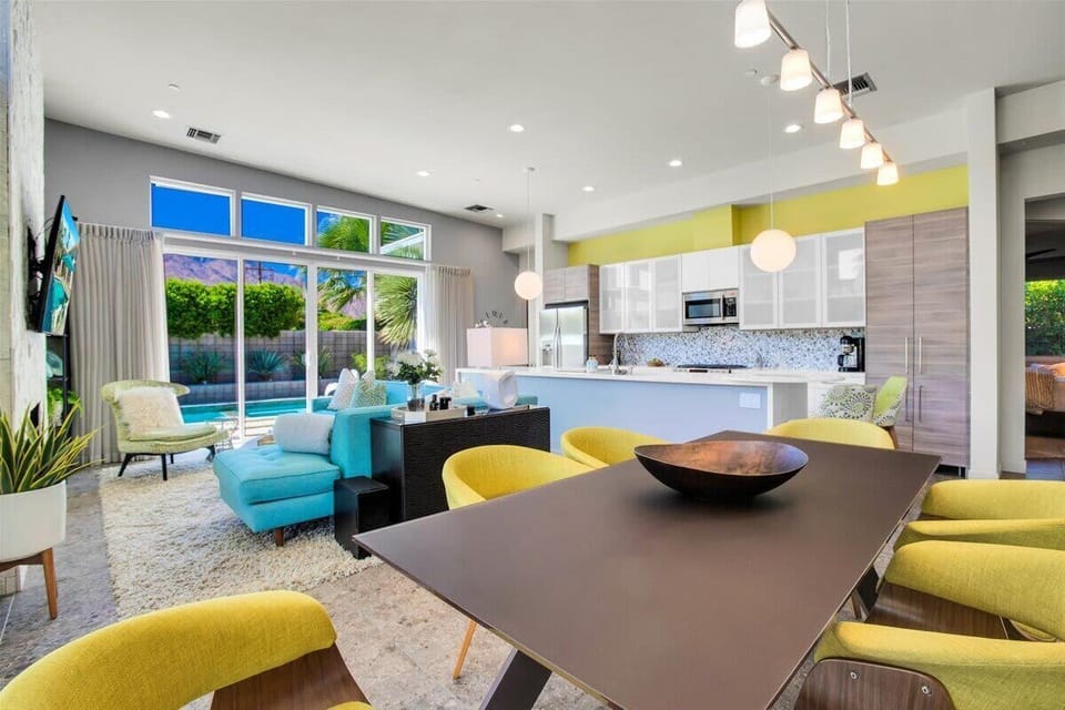 Entertain in style—this spacious mid-century layout flows seamlessly from pool to patio to dining. Dine in elegance in the spacious dining room that comfortably seats six. The fun space creates a warm inviting atmosphere perfect for dinner parties.