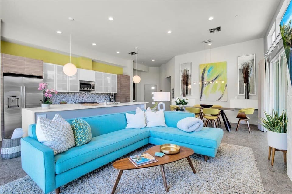 Open living area offers a blend of comfort & sophistication. This chic living room seamlessly melds contemporary design with plush comfort.  Enjoy direct & seamless access to the pool.