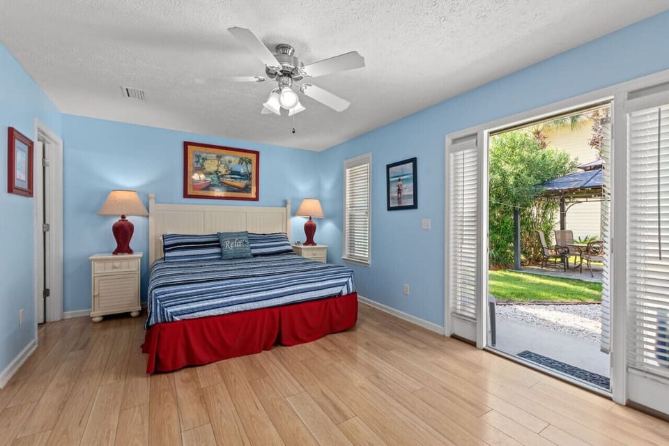 A serene king bedroom with its own backyard access, offering the perfect retreat to relax and step outside for a breath of fresh air!