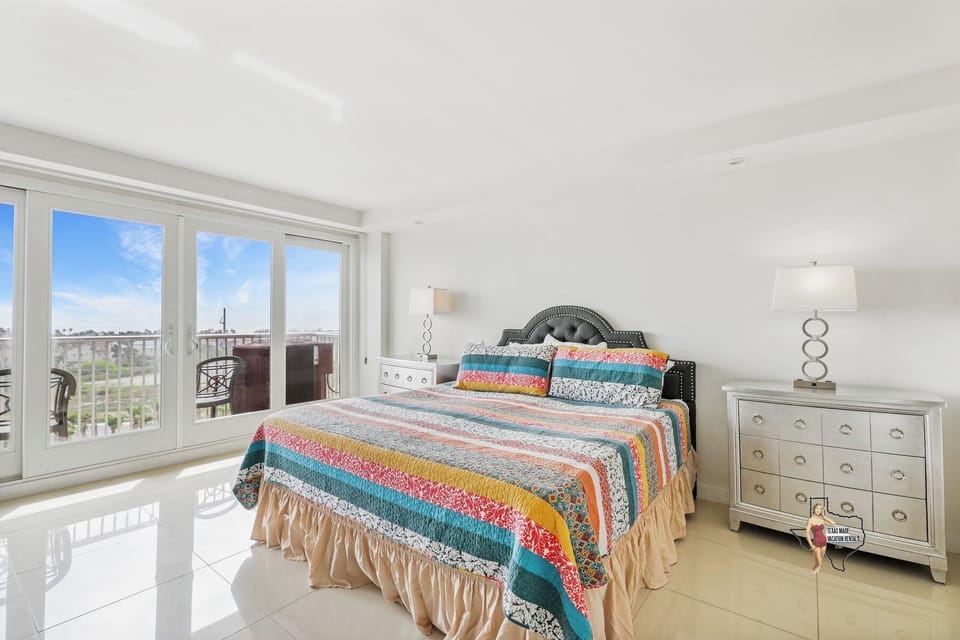 Rest easy in a spacious king bedroom filled with natural light and a scenic view.