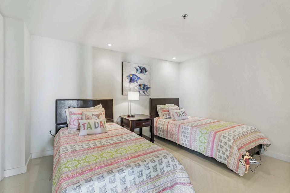 A quiet and cozy 2 single beds, perfect for restful nights, with a TV for entertainment.